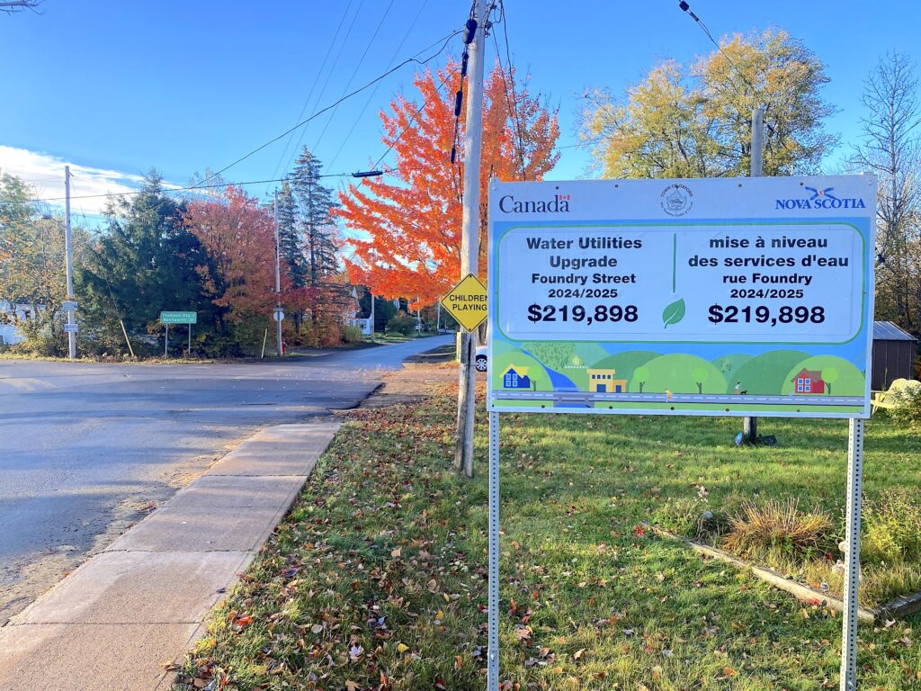 Sign at the intersection of Foundry Street and Birchwood Road indicating the financial contribution of the Federal and Provincial governments to the Foundry Street water and paving project