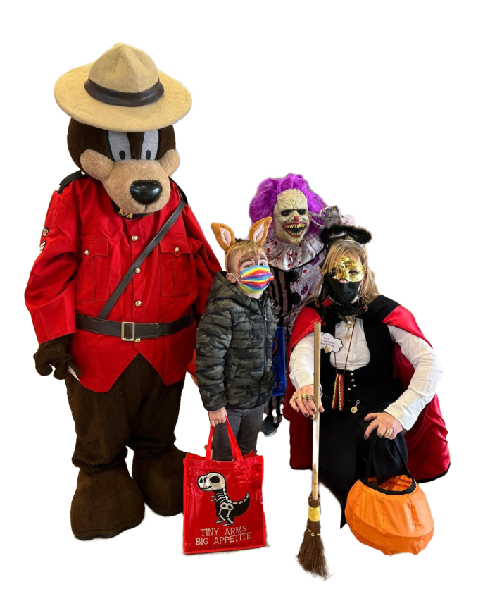 RCMP mascot with kids in halloween costumes